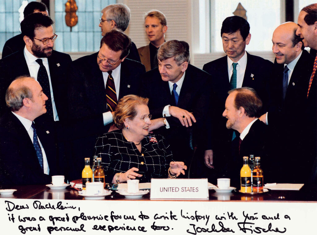 Albright with the G-8 with a signature below that says "Dear Madeleine, It was a great pleasure for me to write history with you and a great personal experience too. Joschka Fischer"